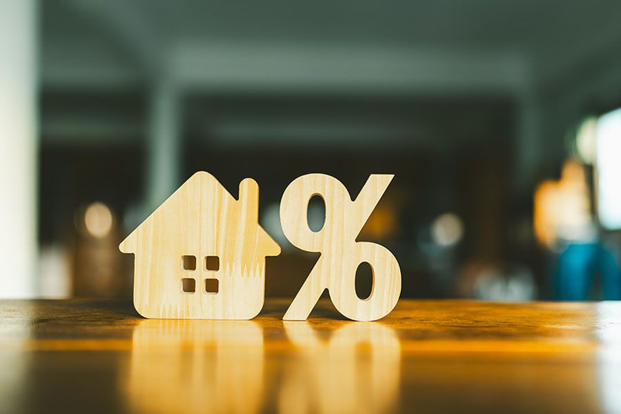 Concept of home loan with wooden percentage and house sign symbol icon