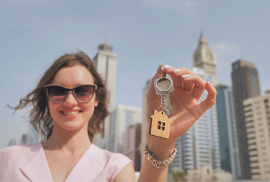 Foreigner in Dubai with property key in her hand
