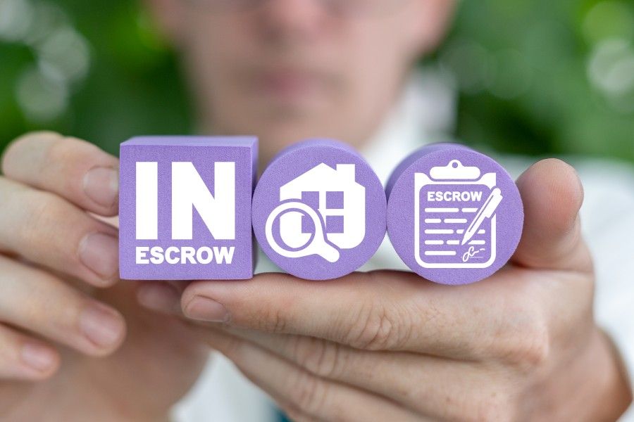 Man holding Escrow account graphics